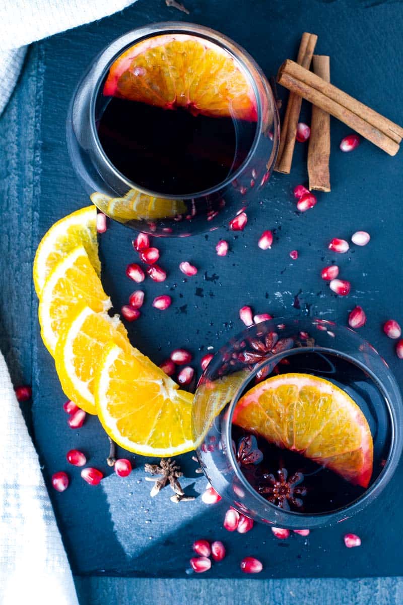 Slow Cooker Spiced Mulled Wine with Pomegranates and Oranges. Sliced oranges and pomegranate seeds.