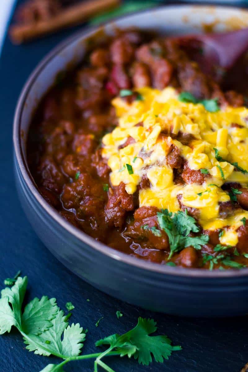 Instant Pot Chili bowl with cheddar cheese and chopped cilantro.
