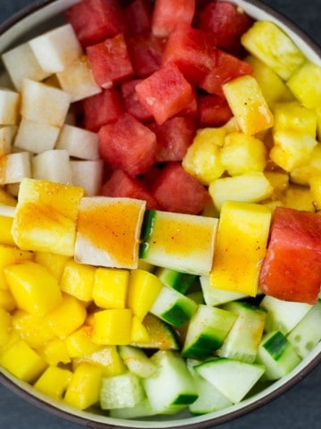 mexican fruit salad of watermelons, cucumbers, jicama and more with lime chili dressing