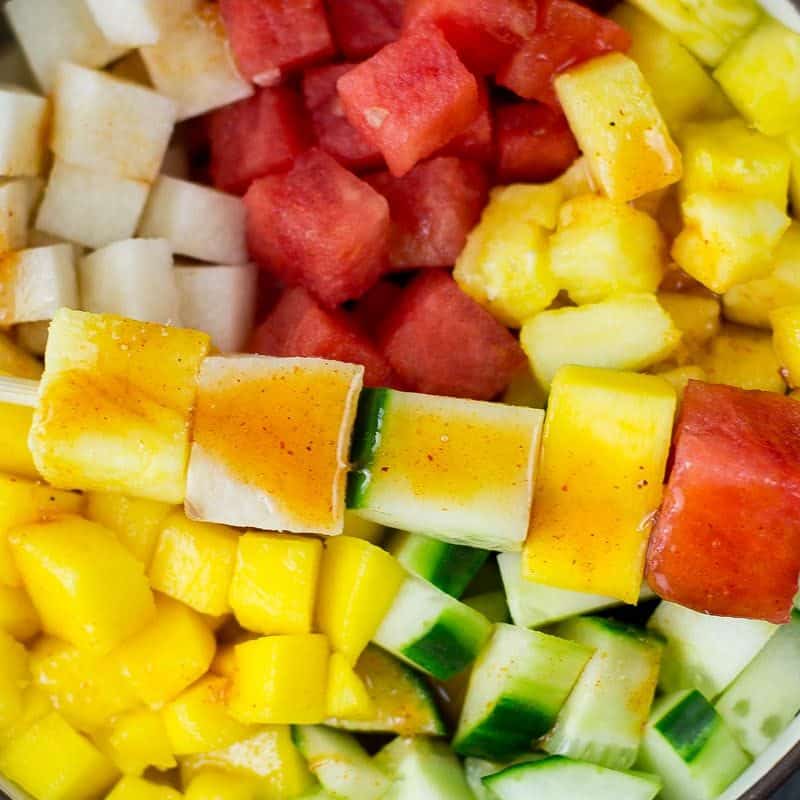 mexican fruit salad of watermelons, cucumbers, jicama and more with lime chili dressing
