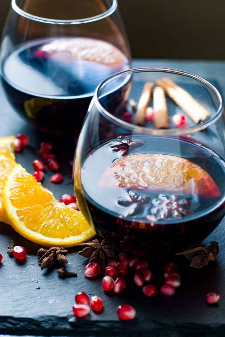 Slow Cooker Spiced Mulled Wine with Pomegranates and Oranges. Two glasses.